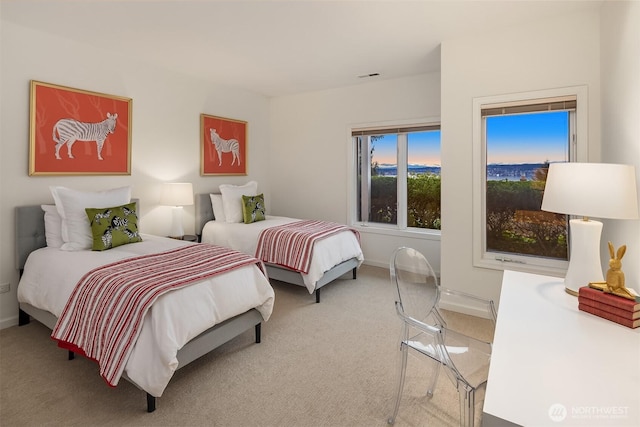 bedroom with visible vents, light colored carpet, and baseboards