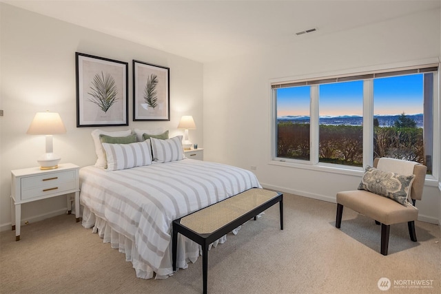 bedroom featuring visible vents, baseboards, and light colored carpet