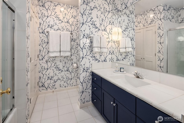 bathroom featuring tile patterned floors, baseboards, vanity, and wallpapered walls