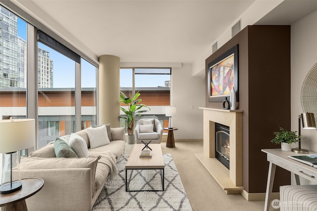 carpeted living area with a premium fireplace, plenty of natural light, and baseboards