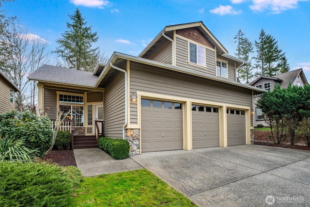 view of front of home featuring stone siding, driveway, and an attached garage