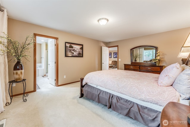 bedroom with light colored carpet, connected bathroom, and baseboards