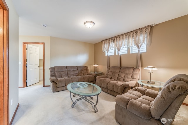 living room featuring baseboards and light carpet