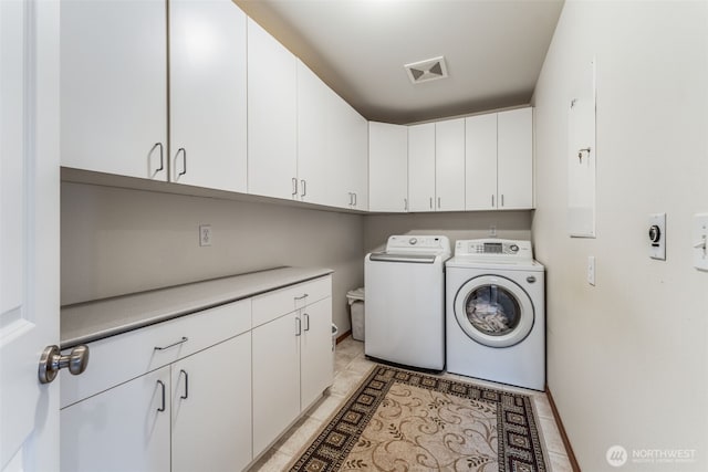 clothes washing area with visible vents, cabinet space, independent washer and dryer, and baseboards