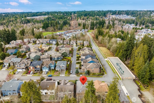 birds eye view of property with a residential view and a view of trees