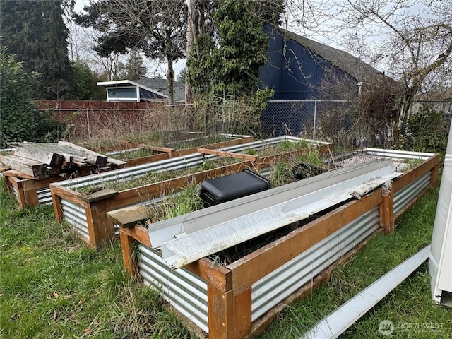 wooden terrace with a garden and fence