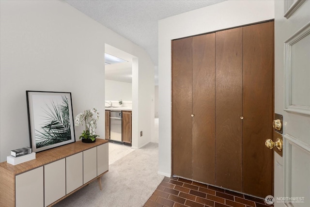 hallway with a textured ceiling