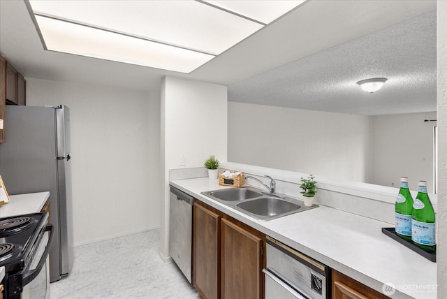 kitchen featuring light countertops, stainless steel dishwasher, a textured ceiling, black / electric stove, and a sink