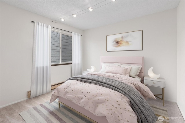 bedroom with baseboards, carpet floors, a textured ceiling, and baseboard heating