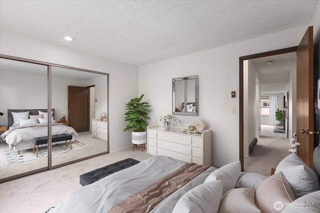 bedroom featuring light colored carpet and a textured ceiling