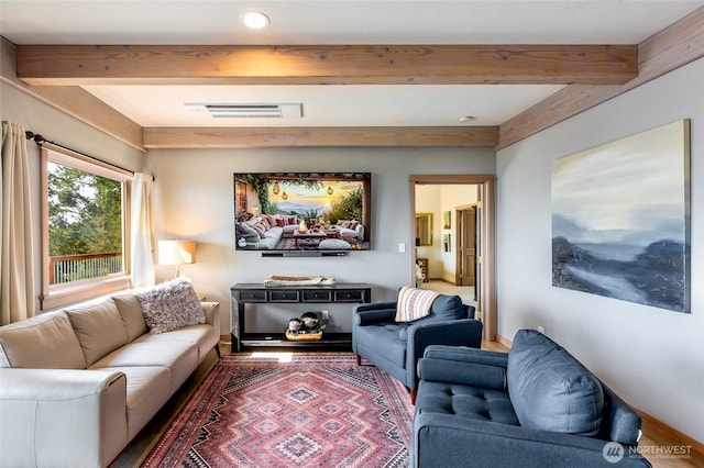 living area featuring recessed lighting, visible vents, and beam ceiling