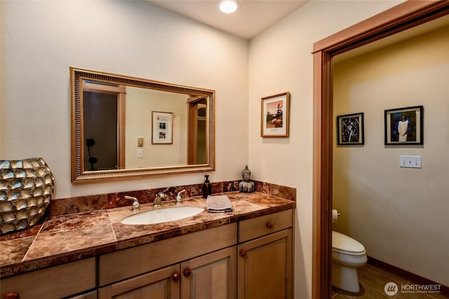bathroom with tile patterned flooring, toilet, and vanity