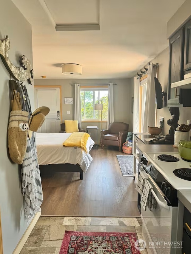 bedroom with attic access and wood finished floors