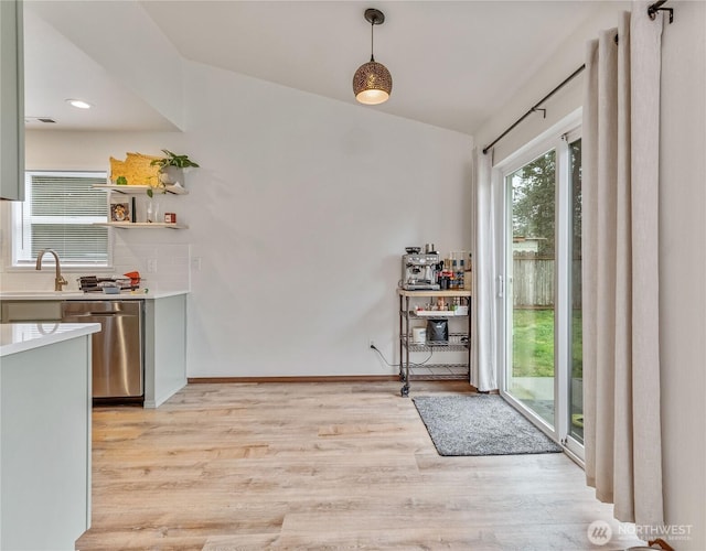 dining area featuring baseboards and light wood-style floors