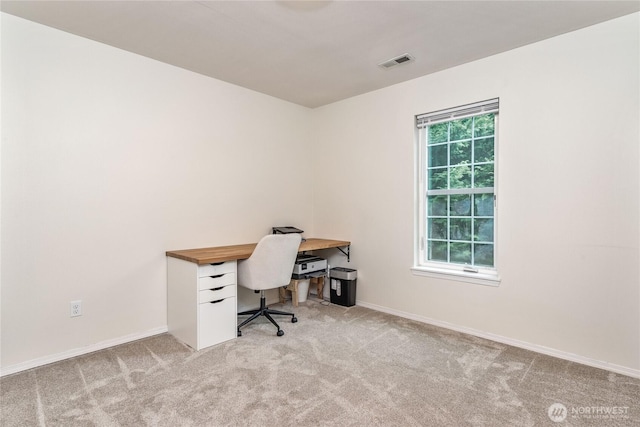 office space with baseboards, visible vents, and carpet floors