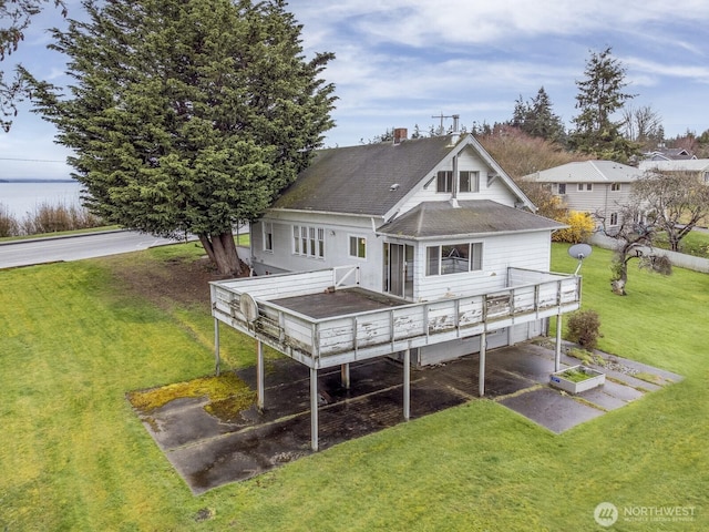 249 Cascade Ave, Langley, WA 98260 - rear view of house with a shingled roof, a deck, and a lawn