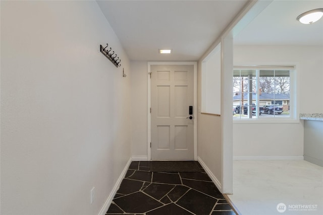 doorway to outside with baseboards