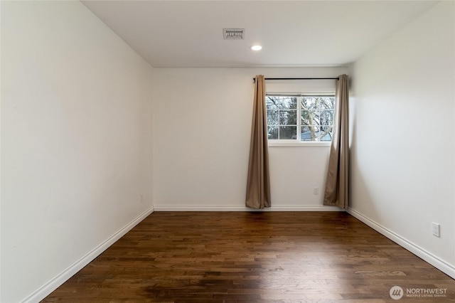 spare room featuring visible vents, recessed lighting, baseboards, and wood finished floors