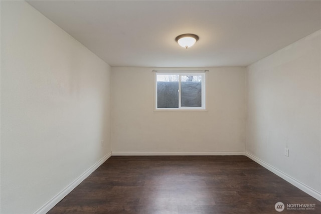 unfurnished room featuring baseboards and wood finished floors