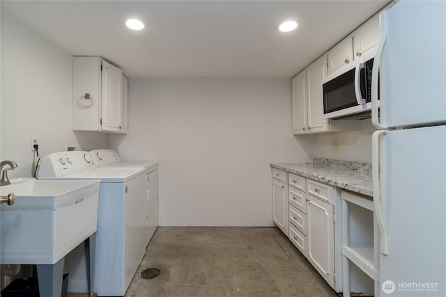 laundry room with washer and clothes dryer, laundry area, recessed lighting, and a sink