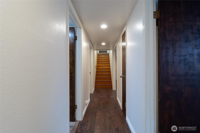 hall with baseboards, stairway, wood finished floors, recessed lighting, and a textured wall