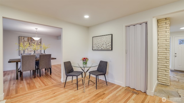 dining area with recessed lighting, wood finished floors, visible vents, and baseboards