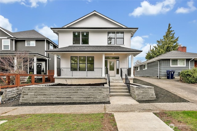 traditional style home featuring covered porch and roof with shingles