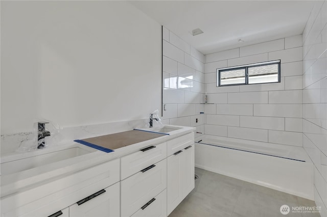 bathroom with a sink, shower / bath combination, and double vanity