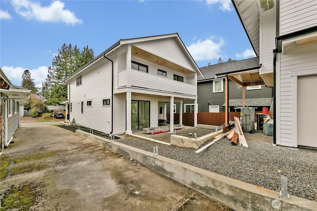 back of house featuring a balcony