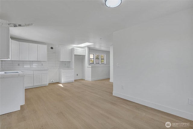4843 N 7th St, Tacoma, WA 98406 - unfurnished living room featuring baseboards and light wood finished floors