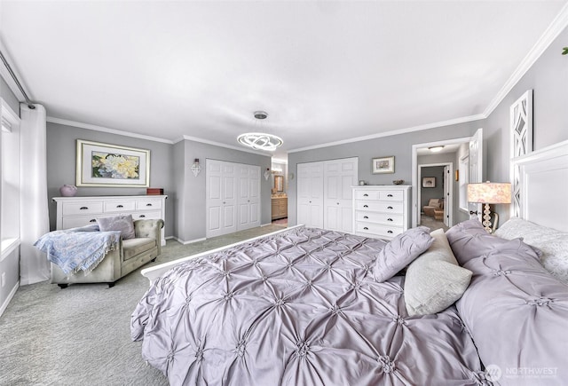 bedroom with carpet flooring, two closets, baseboards, and ornamental molding