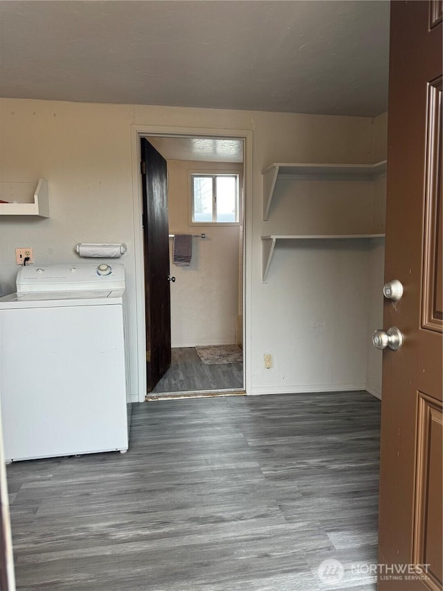 laundry area with laundry area, washer / dryer, and wood finished floors