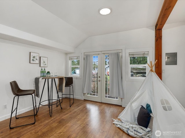 interior space featuring french doors, baseboards, lofted ceiling, and wood finished floors