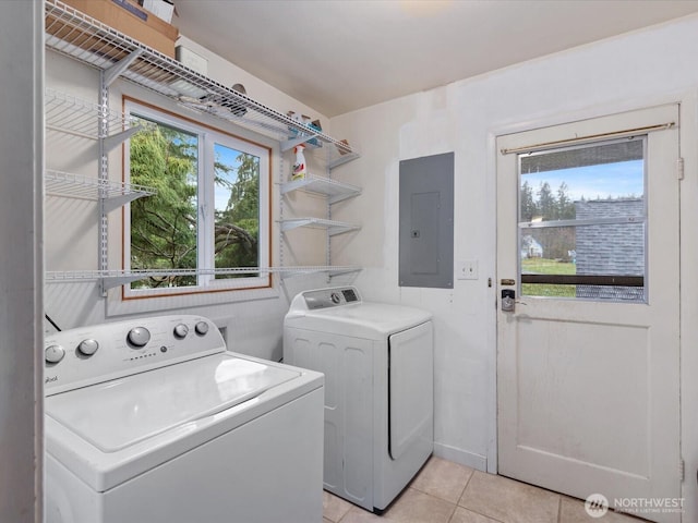 laundry room featuring laundry area, electric panel, independent washer and dryer, and light tile patterned floors