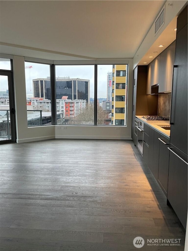 interior space featuring a city view, visible vents, and light wood finished floors