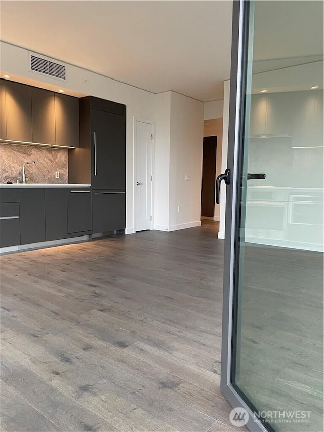 interior space featuring dark wood finished floors, visible vents, and a sink