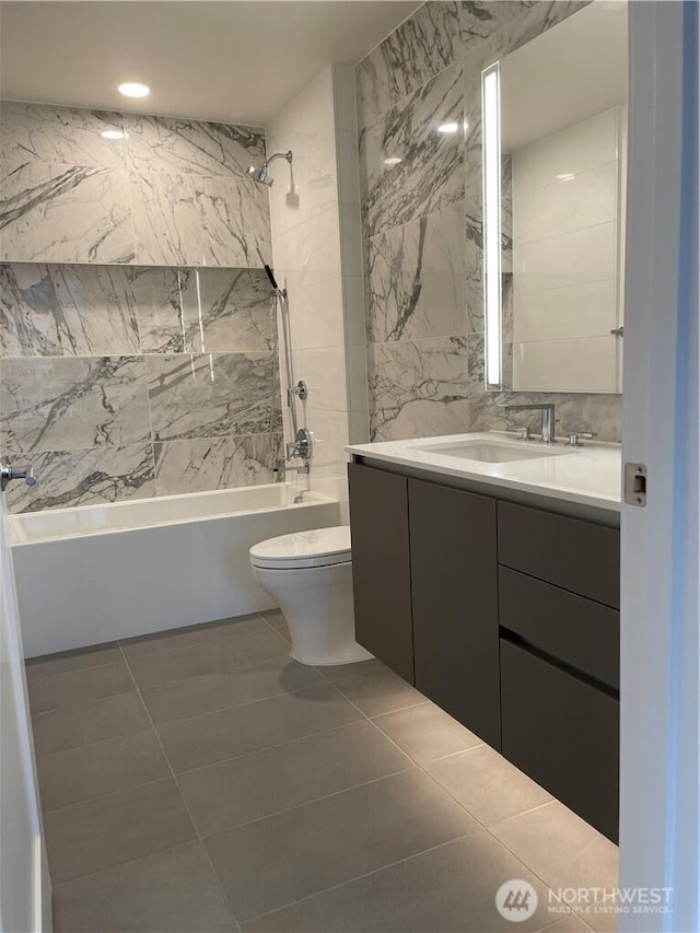 bathroom with toilet, shower / tub combination, tile walls, tile patterned flooring, and vanity