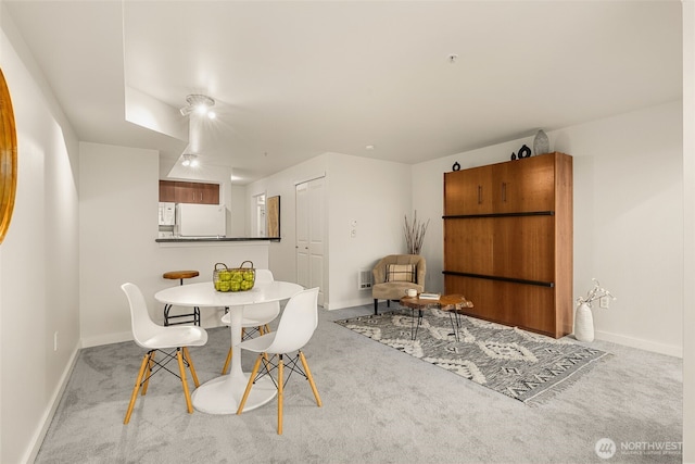 dining area with baseboards and carpet floors