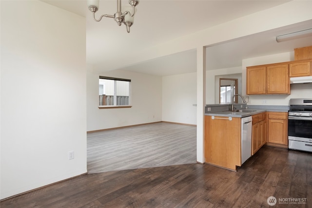 kitchen with under cabinet range hood, a sink, gas stove, white dishwasher, and a healthy amount of sunlight