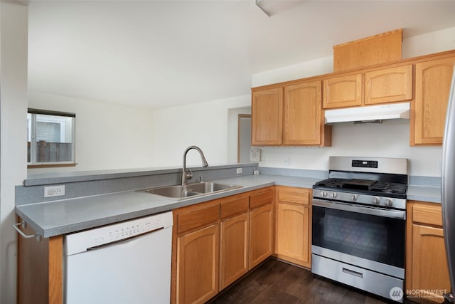 kitchen with under cabinet range hood, a sink, a peninsula, white dishwasher, and stainless steel gas range