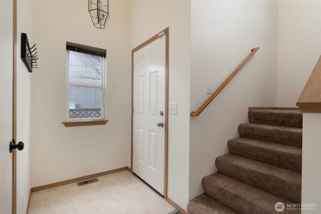 entryway with visible vents, stairs, and baseboards