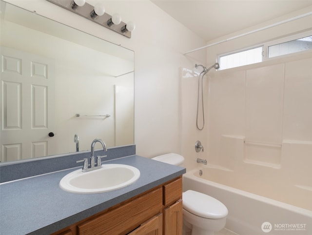 bathroom featuring toilet, vanity, and bathtub / shower combination