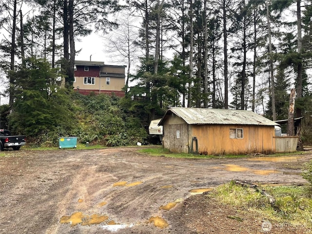 view of side of home with an outdoor structure