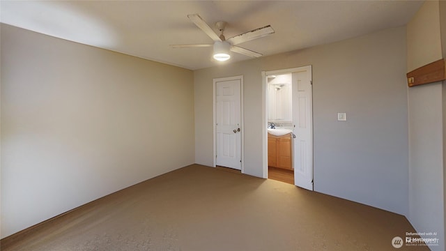 unfurnished bedroom with ensuite bath and a ceiling fan