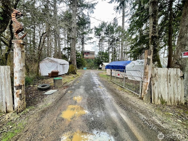 view of street with a gated entry and driveway