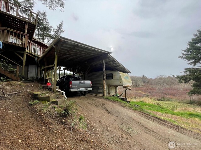 view of vehicle parking with dirt driveway