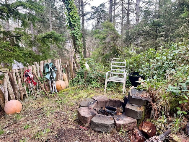 view of yard with a fire pit and fence