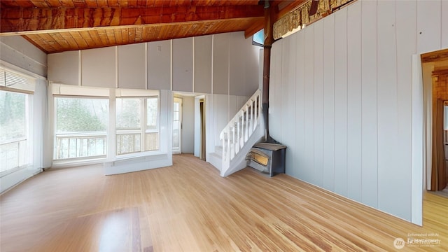 unfurnished living room featuring stairs, wood finished floors, wood ceiling, and vaulted ceiling