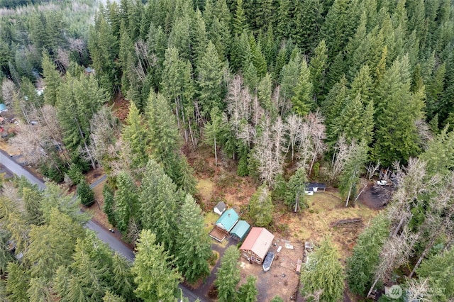 aerial view featuring a wooded view