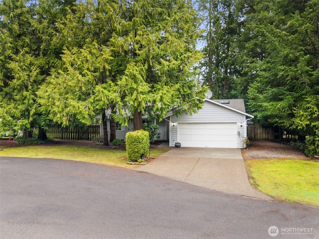 obstructed view of property with a front yard, driveway, fence, and an attached garage